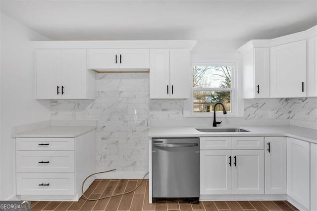 kitchen with white cabinetry, sink, and stainless steel dishwasher