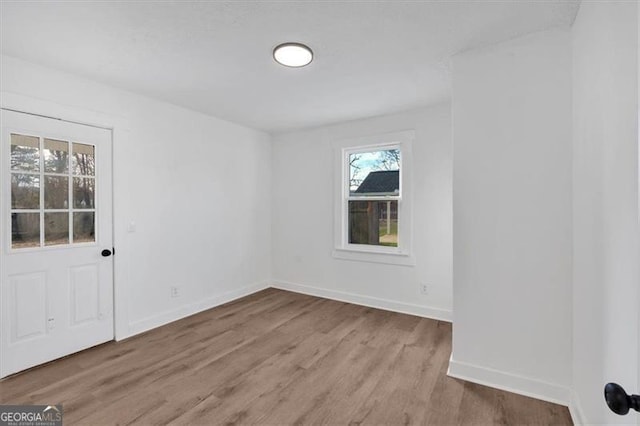 spare room featuring light hardwood / wood-style floors