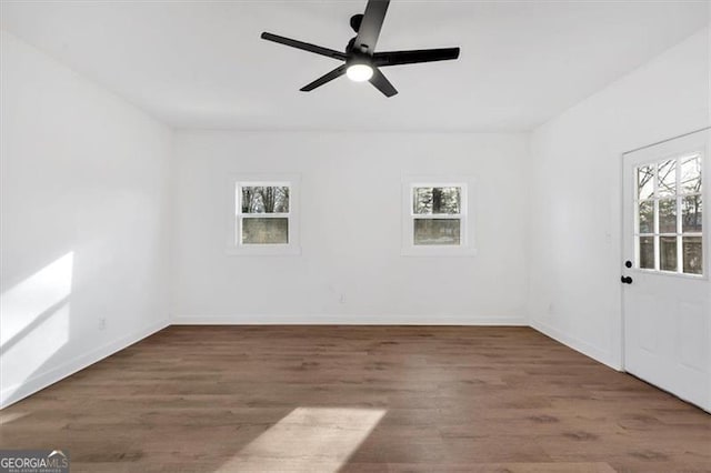 unfurnished room featuring dark hardwood / wood-style flooring and ceiling fan