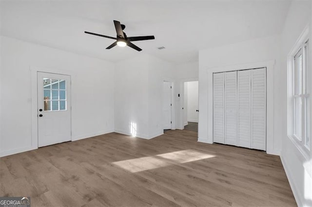 unfurnished bedroom featuring ceiling fan and light hardwood / wood-style flooring