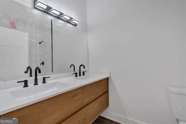 bathroom featuring vanity, tile patterned floors, and toilet