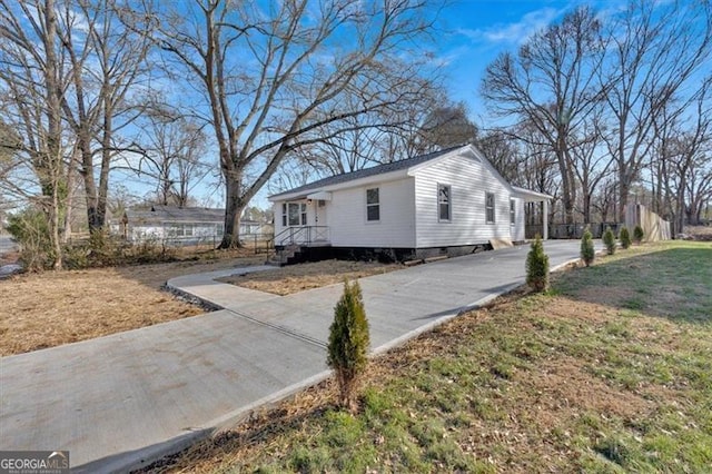 view of side of property with a lawn