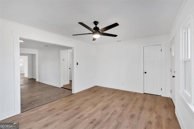 empty room featuring wood-type flooring and ceiling fan