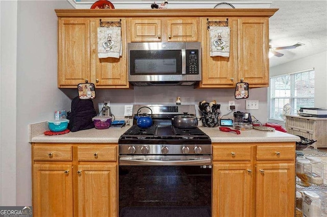 kitchen with appliances with stainless steel finishes and a textured ceiling