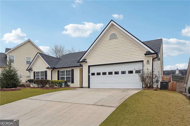 view of front facade with a garage, a front yard, and central air condition unit