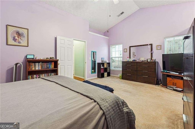 bedroom with high vaulted ceiling, light carpet, a textured ceiling, and ceiling fan