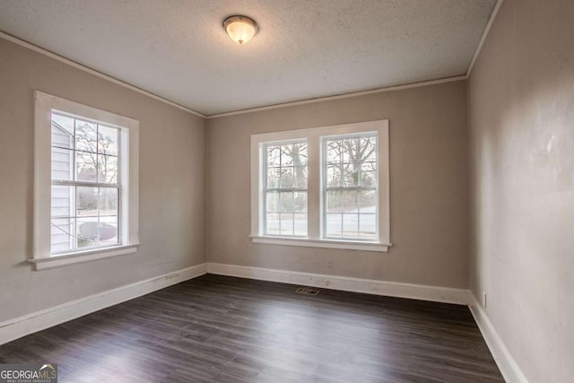 empty room with crown molding, a textured ceiling, and dark hardwood / wood-style flooring