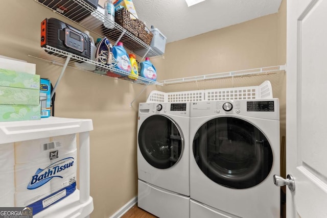 washroom featuring washing machine and clothes dryer