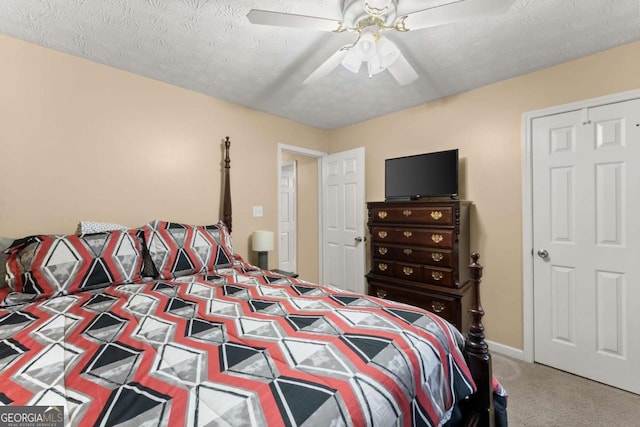 carpeted bedroom featuring a textured ceiling and ceiling fan