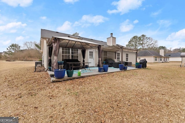 back of house with a gazebo, a yard, central AC, and a patio