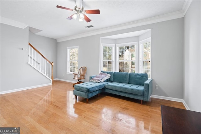 sitting room with crown molding, hardwood / wood-style flooring, and ceiling fan