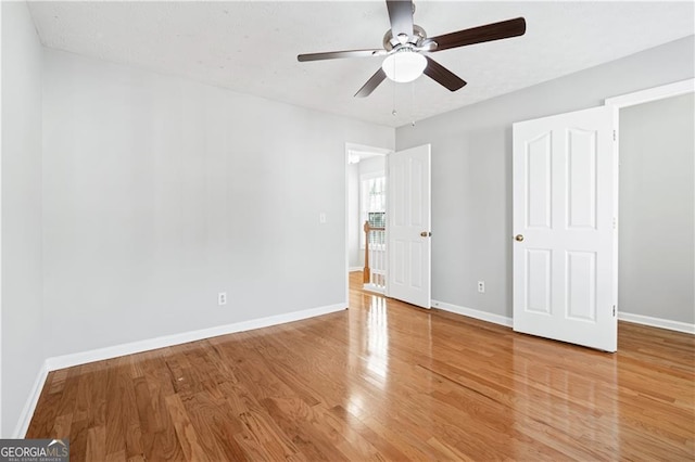 unfurnished bedroom with ceiling fan and wood-type flooring