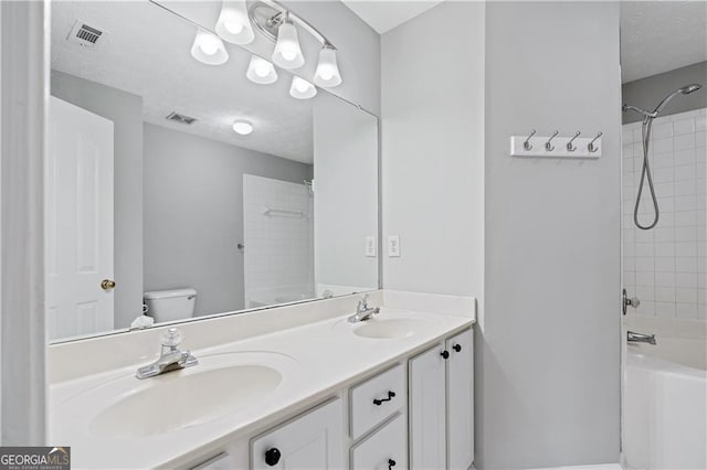 full bathroom featuring vanity, toilet, and tiled shower / bath combo