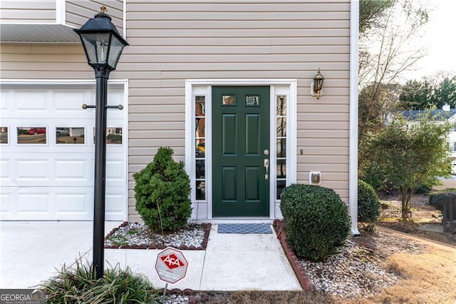 view of exterior entry with a garage