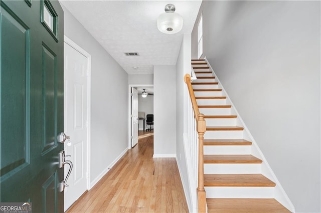 foyer with light hardwood / wood-style flooring and a textured ceiling