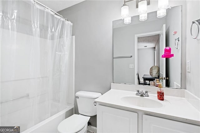 full bathroom with vanity, shower / bath combo with shower curtain, and toilet