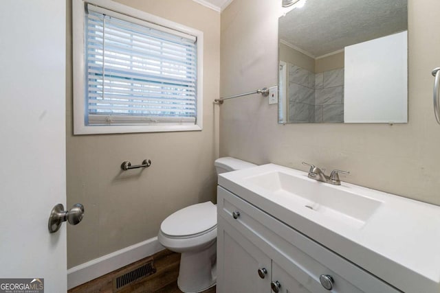 bathroom featuring hardwood / wood-style flooring, vanity, a textured ceiling, and toilet