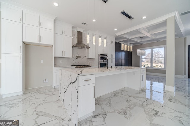 kitchen with recessed lighting, marble finish floor, white cabinetry, and wall chimney range hood