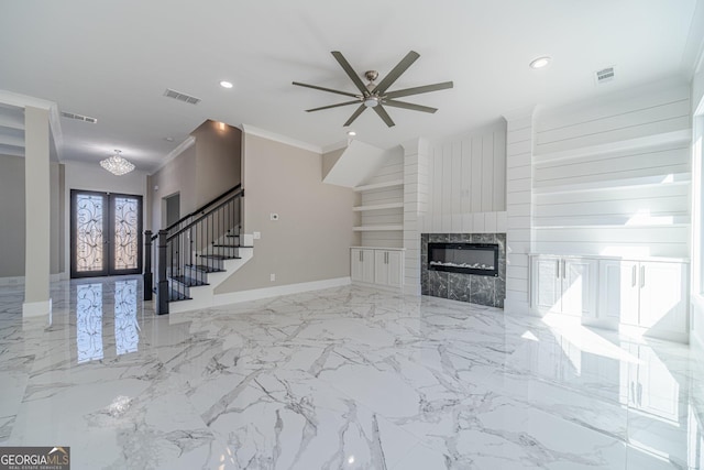 unfurnished living room featuring crown molding, a fireplace, french doors, and ceiling fan