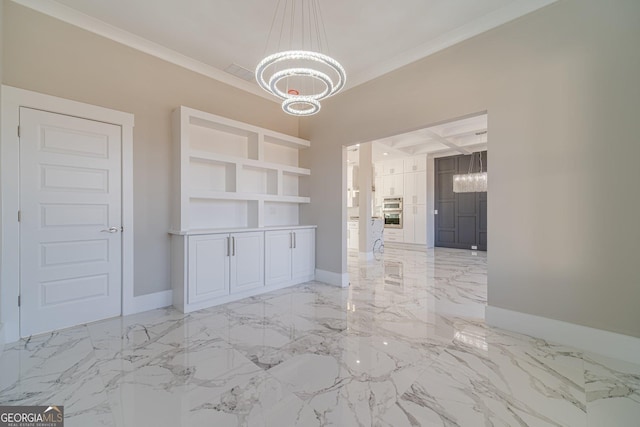 unfurnished dining area with an inviting chandelier, ornamental molding, and coffered ceiling