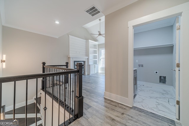 hall with marble finish floor, an upstairs landing, visible vents, and baseboards