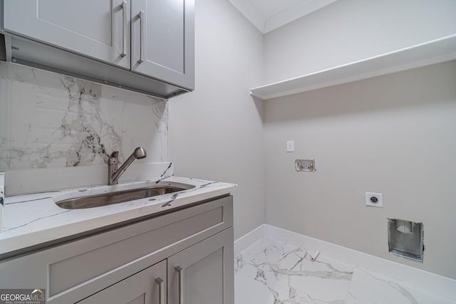 laundry area with cabinet space, hookup for a washing machine, marble finish floor, electric dryer hookup, and a sink