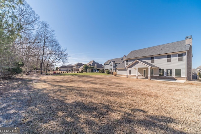 1785 Traditions Way, Jefferson, GA 30549 - back of house with a residential view and a chimney