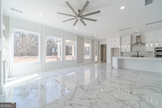 unfurnished living room featuring marble finish floor, visible vents, a ceiling fan, and recessed lighting