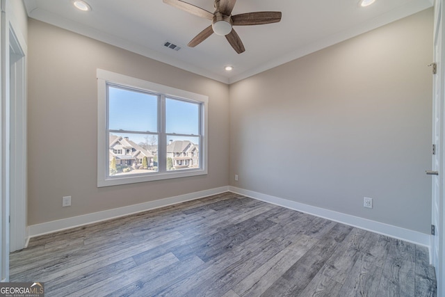 empty room featuring recessed lighting, visible vents, baseboards, and wood finished floors