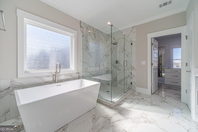 bathroom with a shower with door, crown molding, plenty of natural light, and vanity