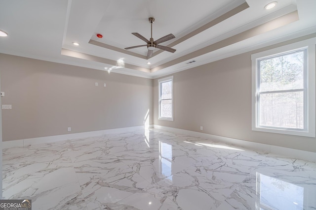 empty room featuring visible vents, ornamental molding, marble finish floor, a tray ceiling, and recessed lighting