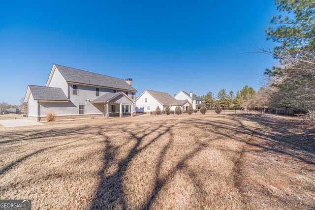 view of yard featuring ceiling fan and a patio