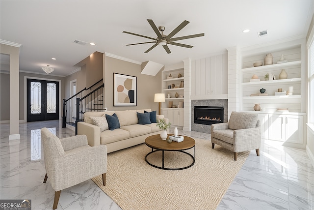 1785 Traditions Way, Jefferson, GA 30549 - living area with crown molding, light marble finish flooring, ceiling fan, built in shelves, and a high end fireplace