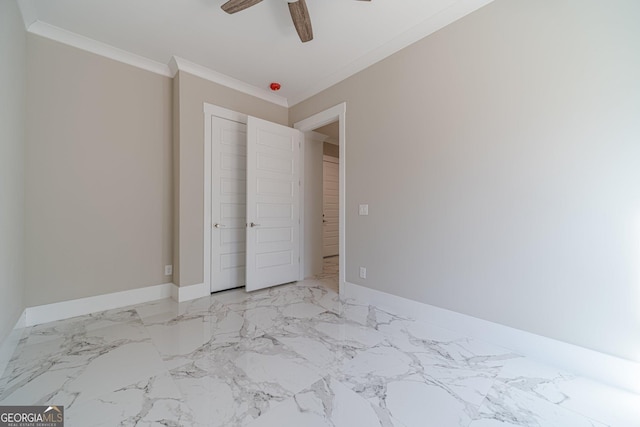 unfurnished bedroom featuring marble finish floor, crown molding, baseboards, and ceiling fan