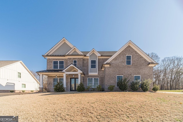 view of front facade featuring brick siding and a front lawn