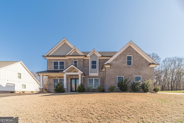 1785 Traditions Way, Jefferson, GA 30549 - view of front of house with brick siding, a front yard, and a standing seam roof