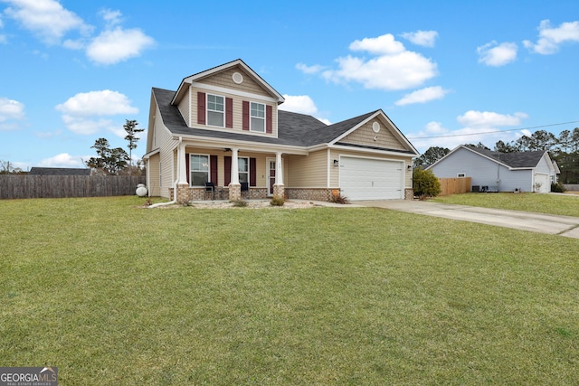 view of front of house with a porch, a garage, and a front yard