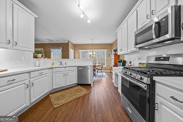 kitchen with stainless steel appliances and white cabinetry