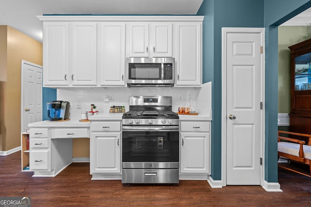 kitchen with tasteful backsplash, white cabinetry, appliances with stainless steel finishes, and dark hardwood / wood-style flooring