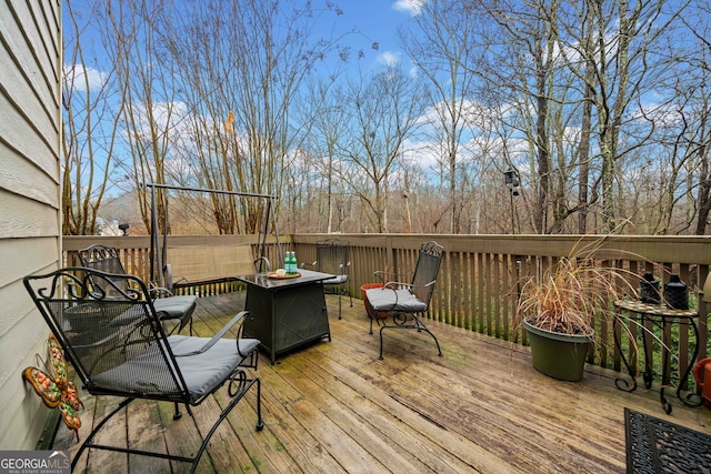 wooden deck featuring an outdoor fire pit