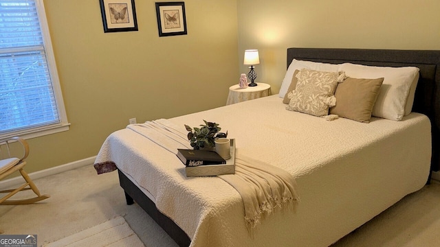 bedroom featuring light carpet