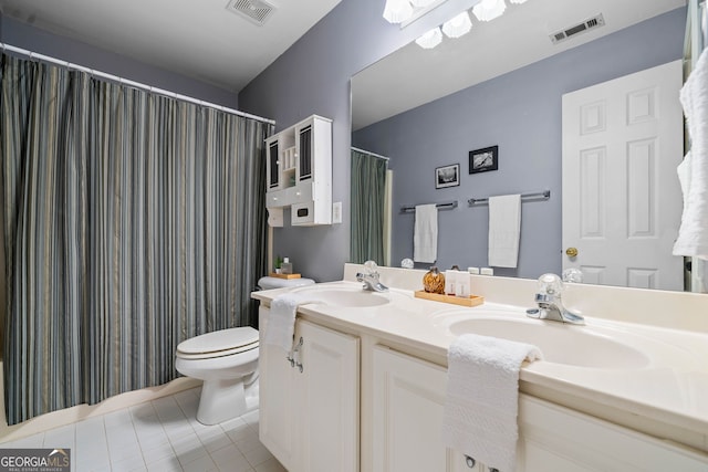 bathroom with vanity, tile patterned flooring, and toilet