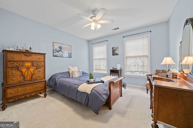 bedroom featuring light colored carpet and ceiling fan