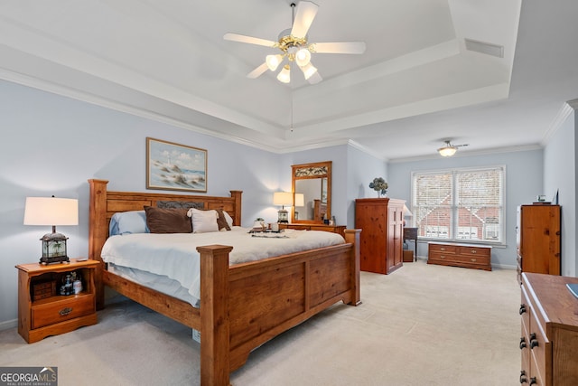 bedroom featuring a raised ceiling, crown molding, light colored carpet, and ceiling fan