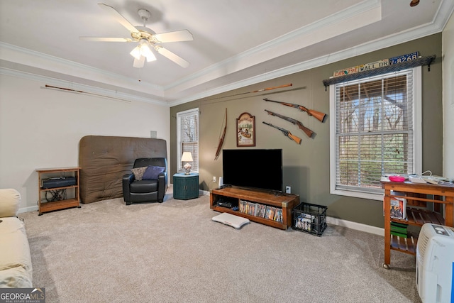 interior space with crown molding, a tray ceiling, and ceiling fan