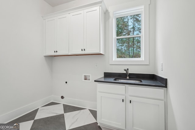 clothes washing area with cabinets, sink, hookup for a washing machine, and electric dryer hookup