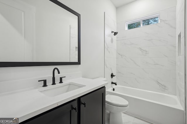 full bathroom with tiled shower / bath, vanity, and toilet