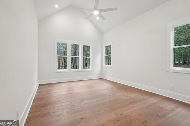 unfurnished room featuring ceiling fan, light wood-type flooring, and high vaulted ceiling