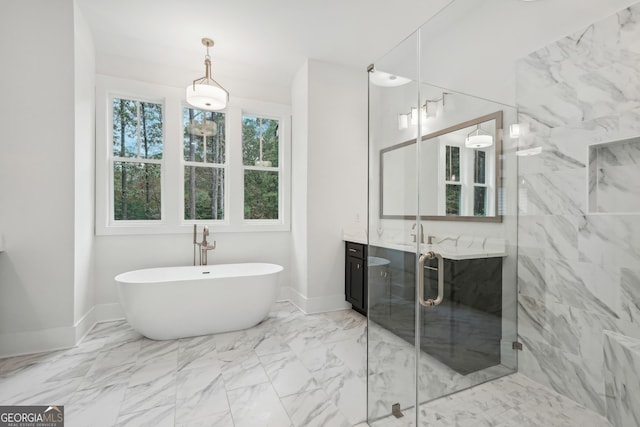 bathroom with vanity and shower with separate bathtub