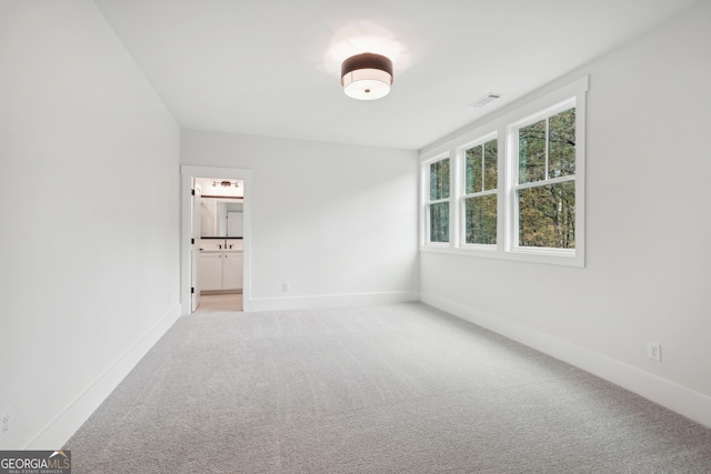 unfurnished room with light colored carpet